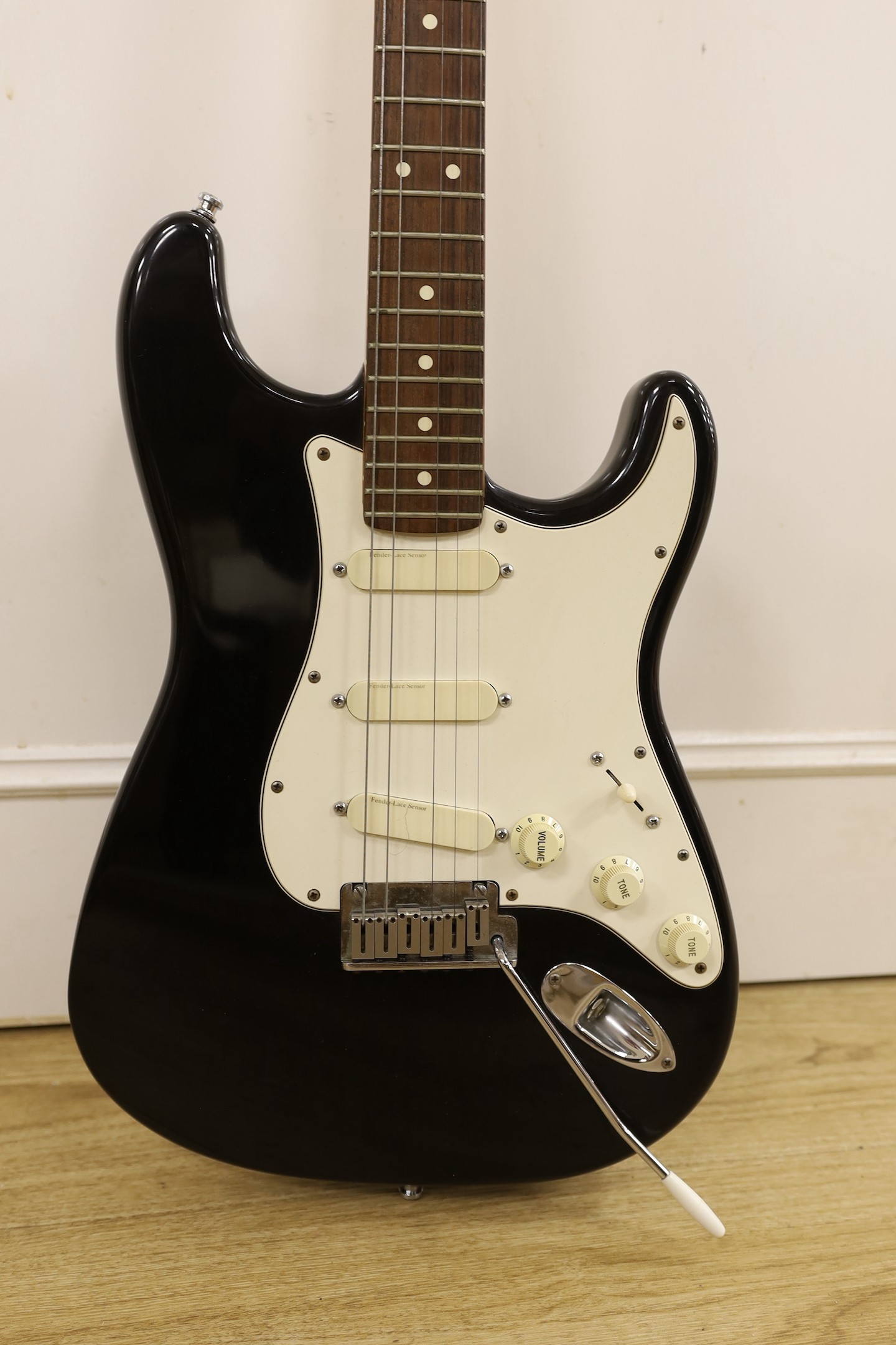 A 1980’s Fender Stratocaster, U.S.A. Serial No. E451951, lace sensor pickups with hard flight case, 98cms high.
